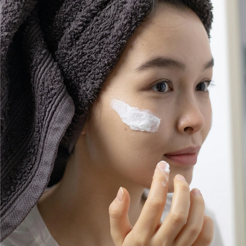 Applying moisturiser to slightly damp skin for better absorption