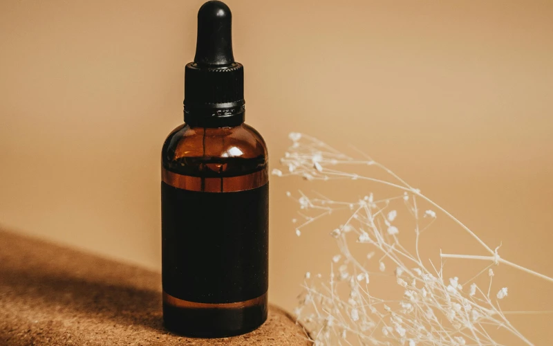 Amber retinol serum bottle representing skin purging adjustment phase in new skincare routine