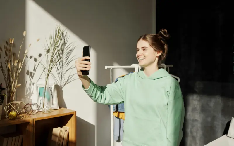 person taking weekly skincare progress photo in natural window light for skin tracking to check how long does skincare take to work