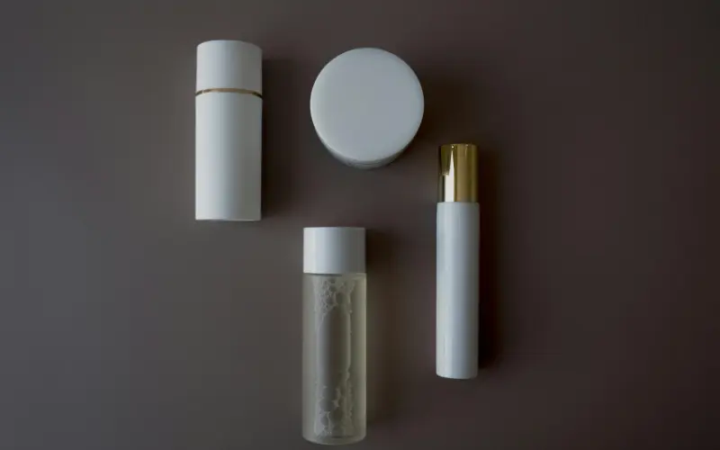 four skincare products on a neutral background showing items suitable for both morning and night skincare routine