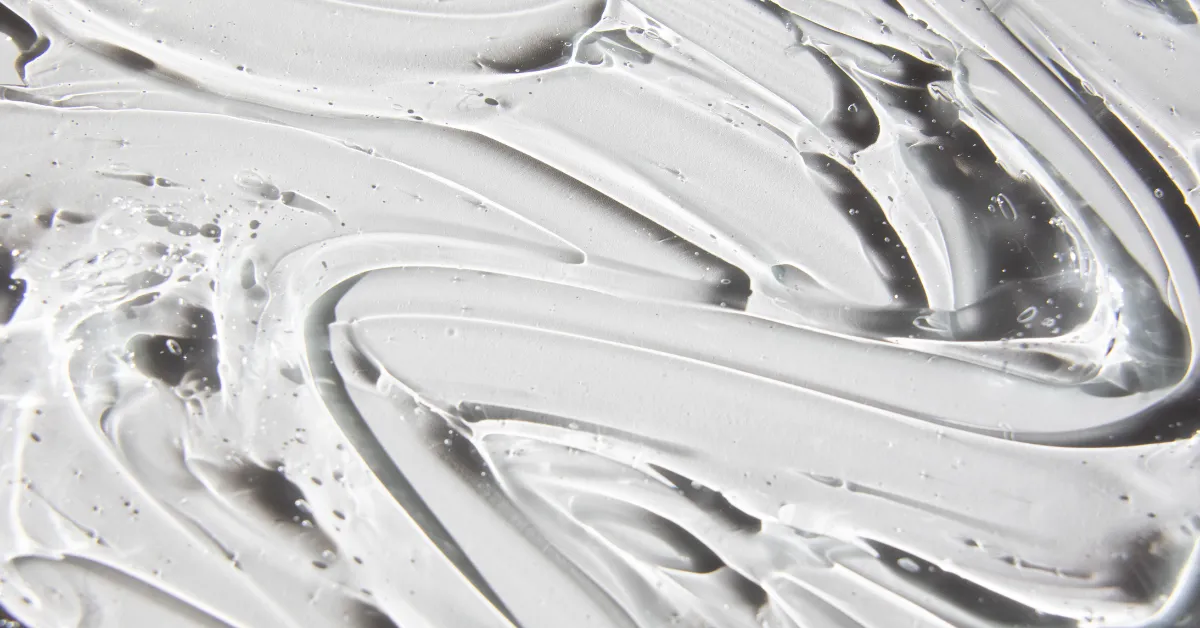 Close-up of a pale cream texture swirl representing snail mucin gel consistency