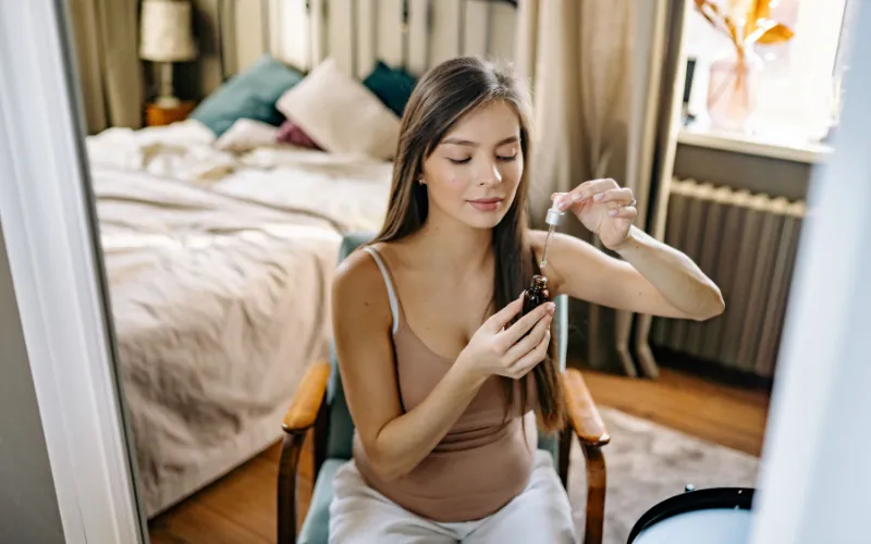 Pregnant woman applying skincare serum, illustrating the tranexamic acid pregnancy safety question